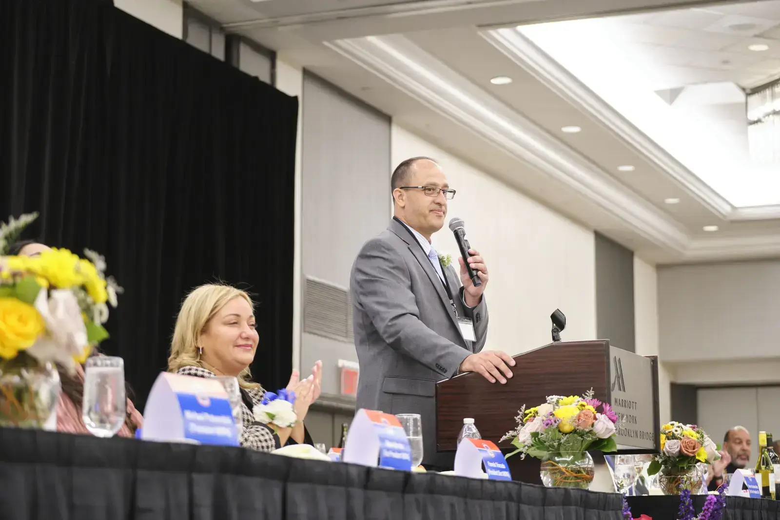 Speaker addressing audience at school event podium
