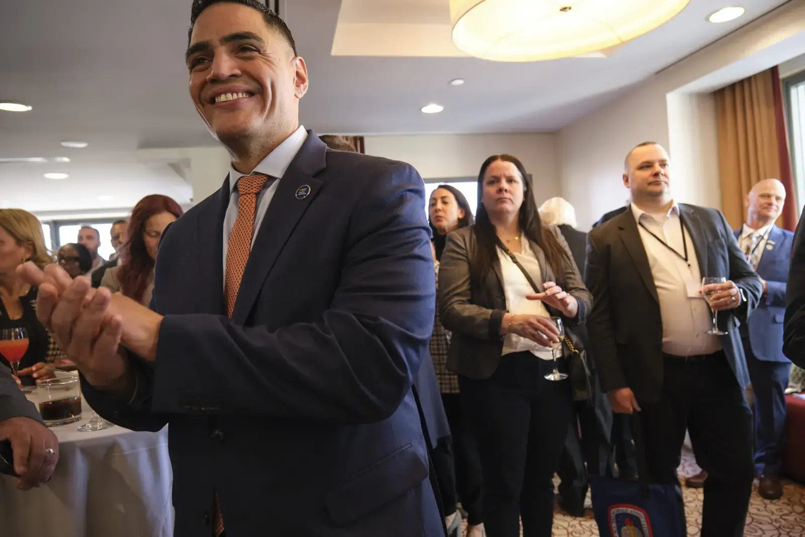 Man in suit applauding at professional networking event