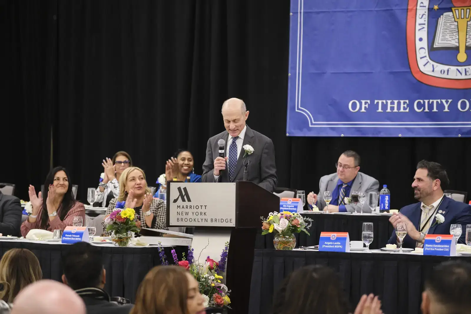 Speaker addressing audience at formal banquet event