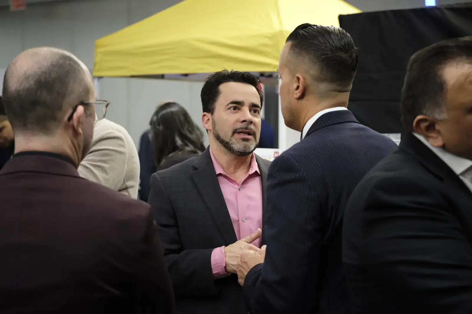 Professionals networking and conversing at career fair event