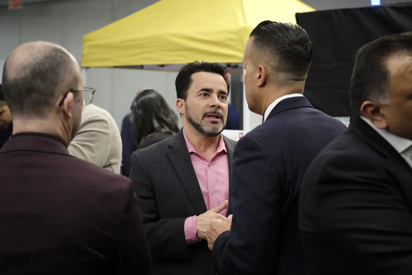 Professionals networking and conversing at career fair event