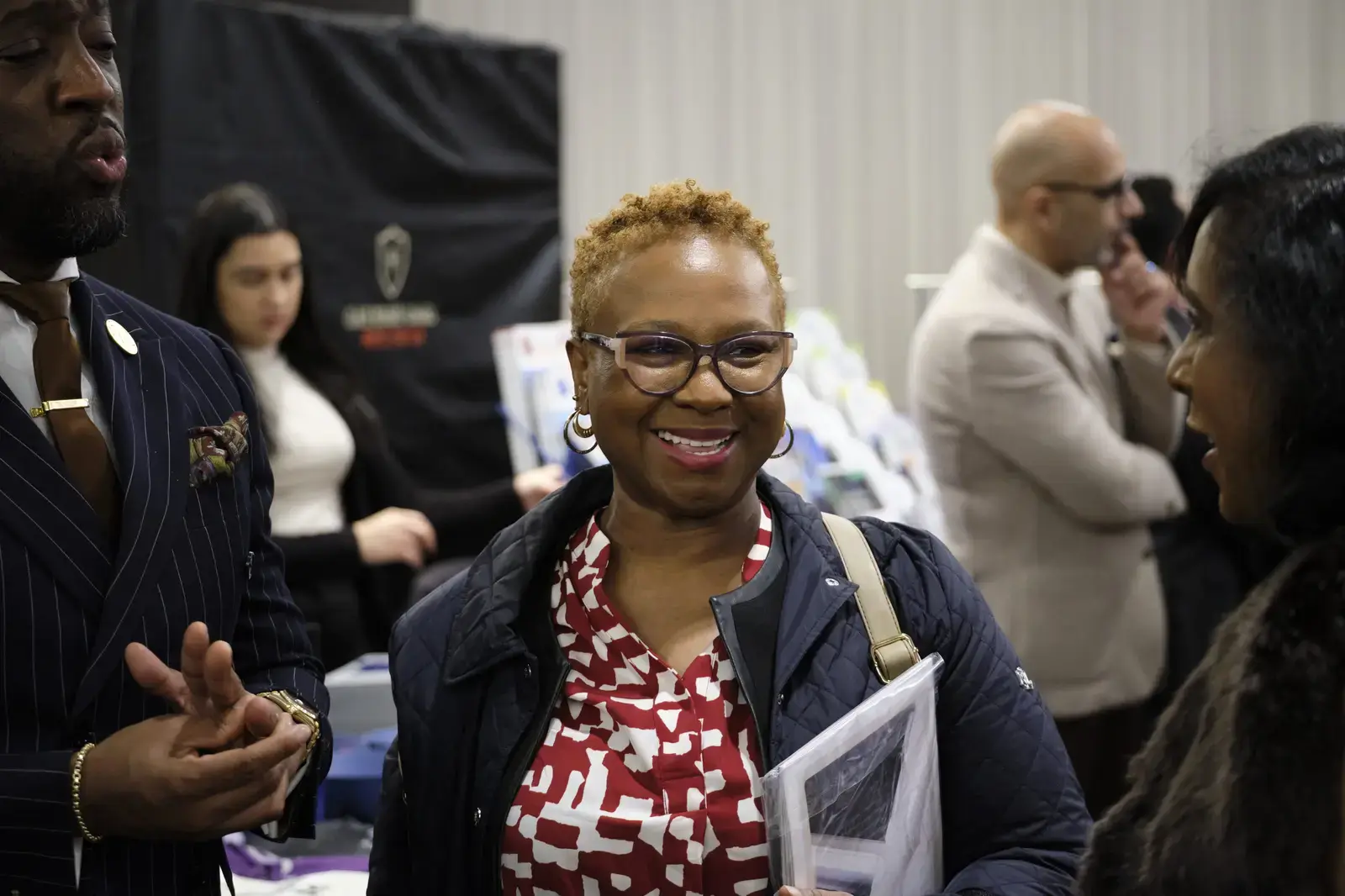Woman with glasses smiling at school event or fair