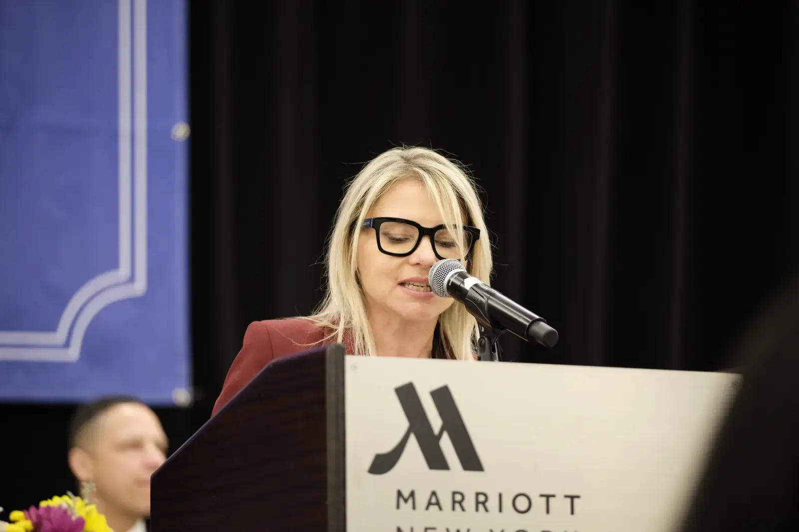 Woman speaking at podium during school event