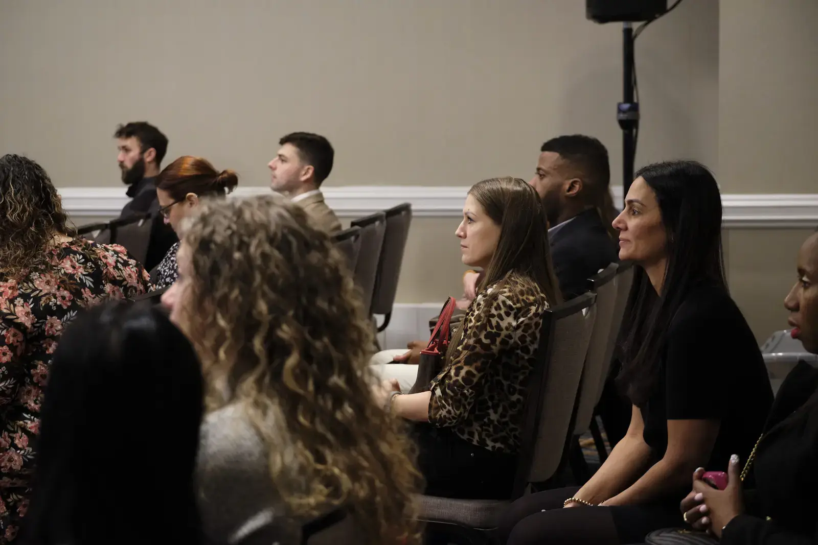 Audience members seated and attentively listening at presentation