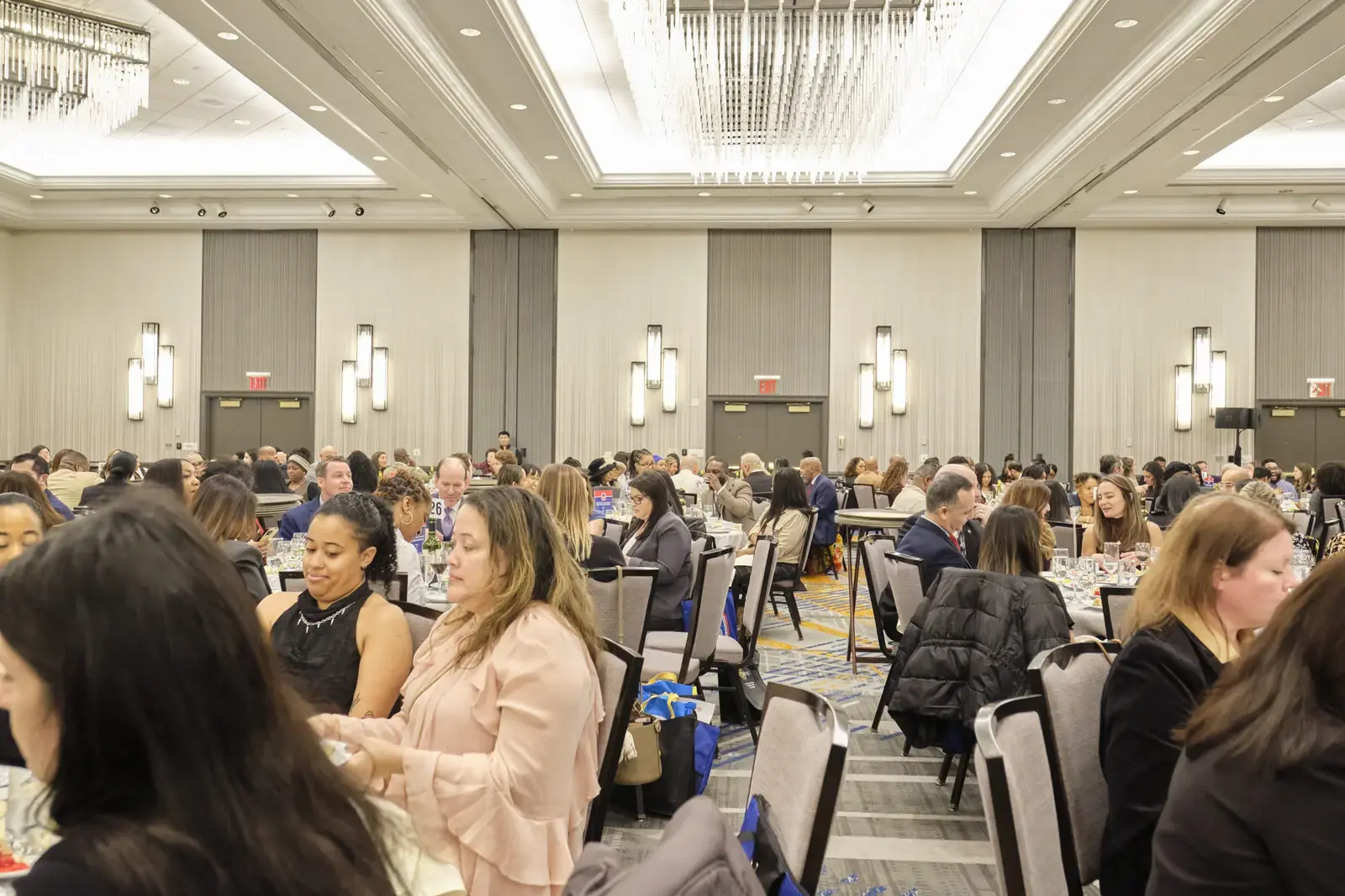Attendees seated at tables during school community event