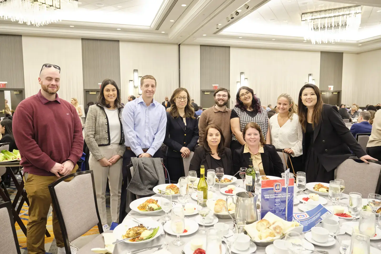 Group of staff members posing at awards luncheon event