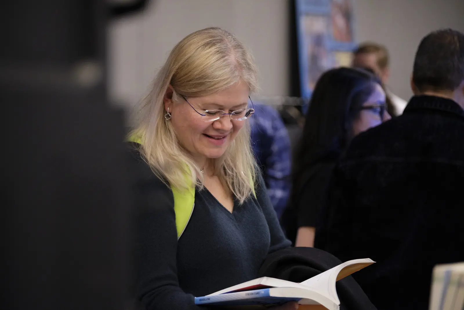 Woman reading brochure at school event