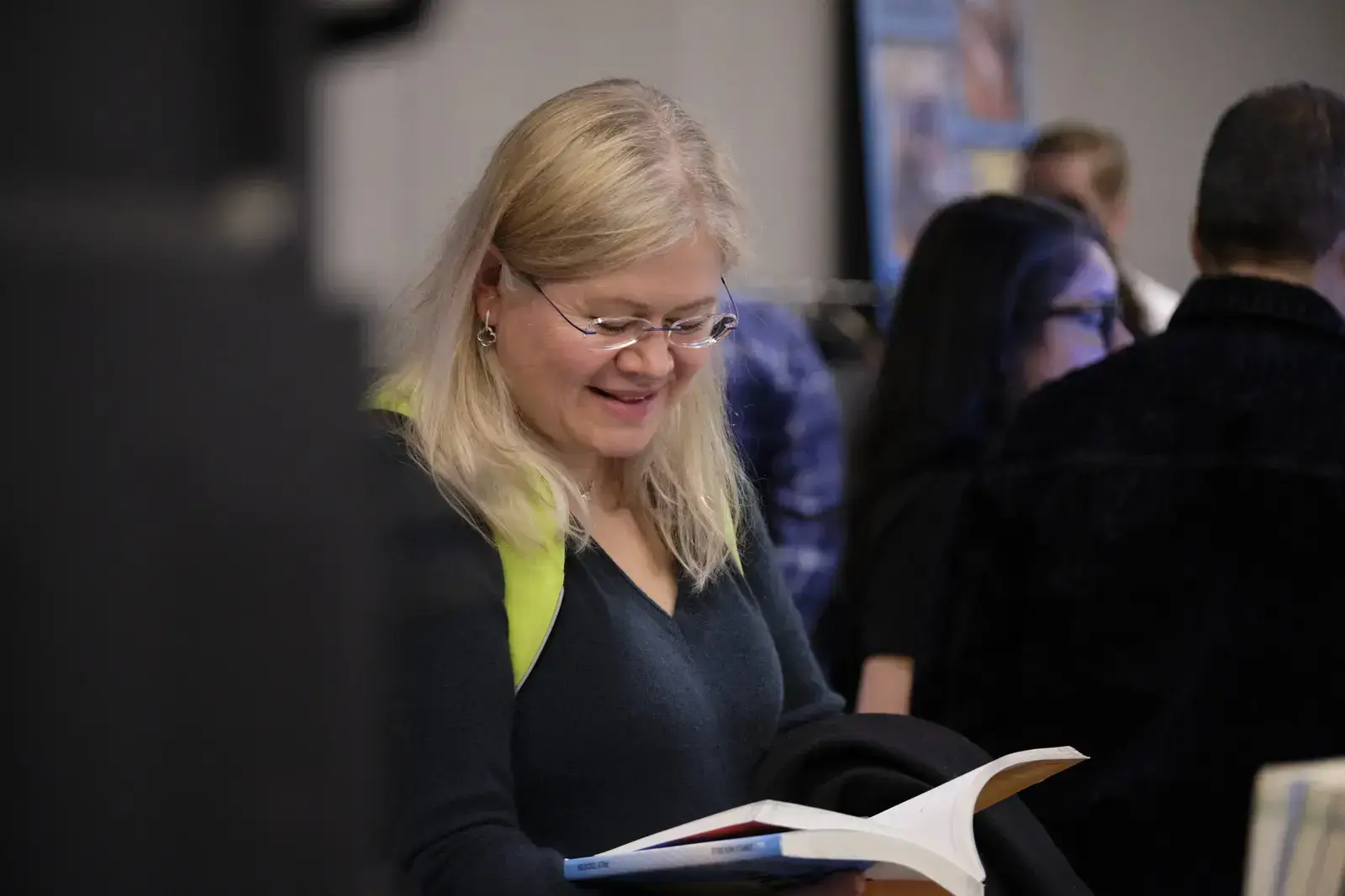 Woman reading brochure at school event