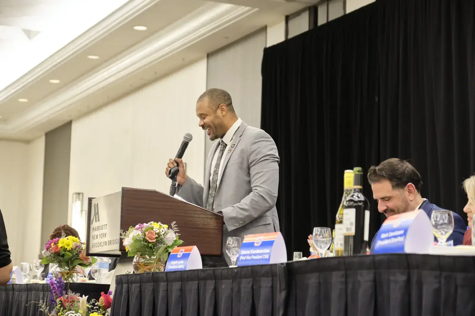 Speaker addressing audience at podium during school event
