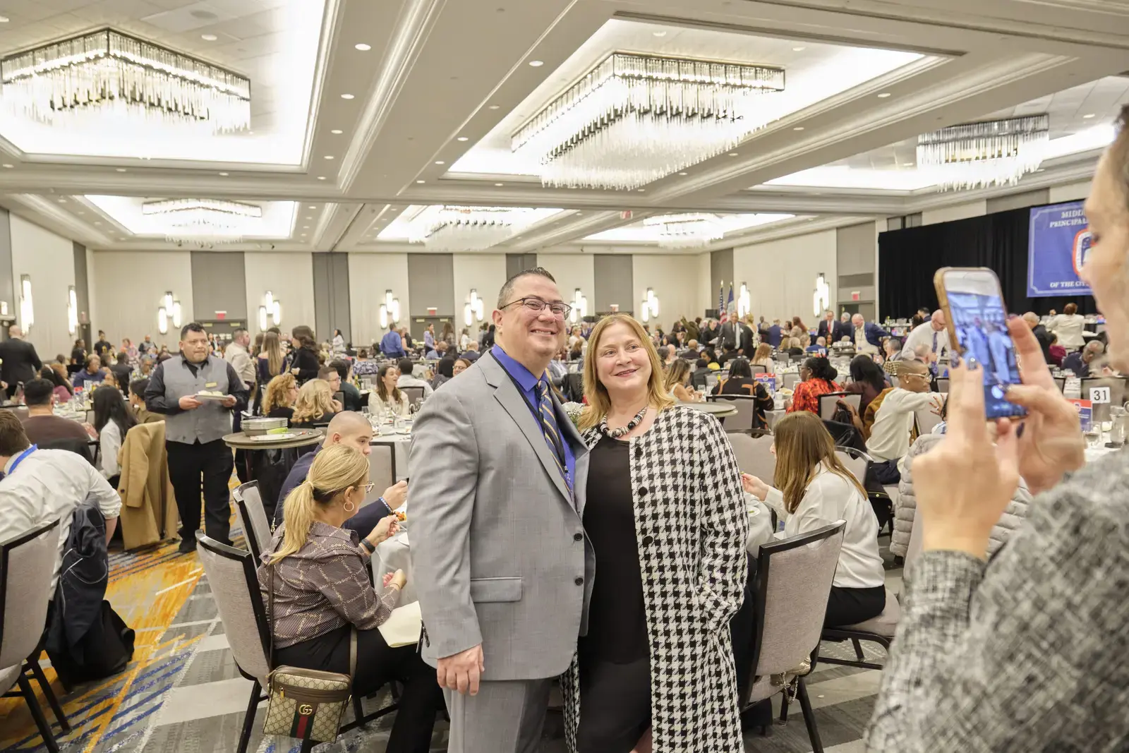 Two people posing for photo at school banquet event