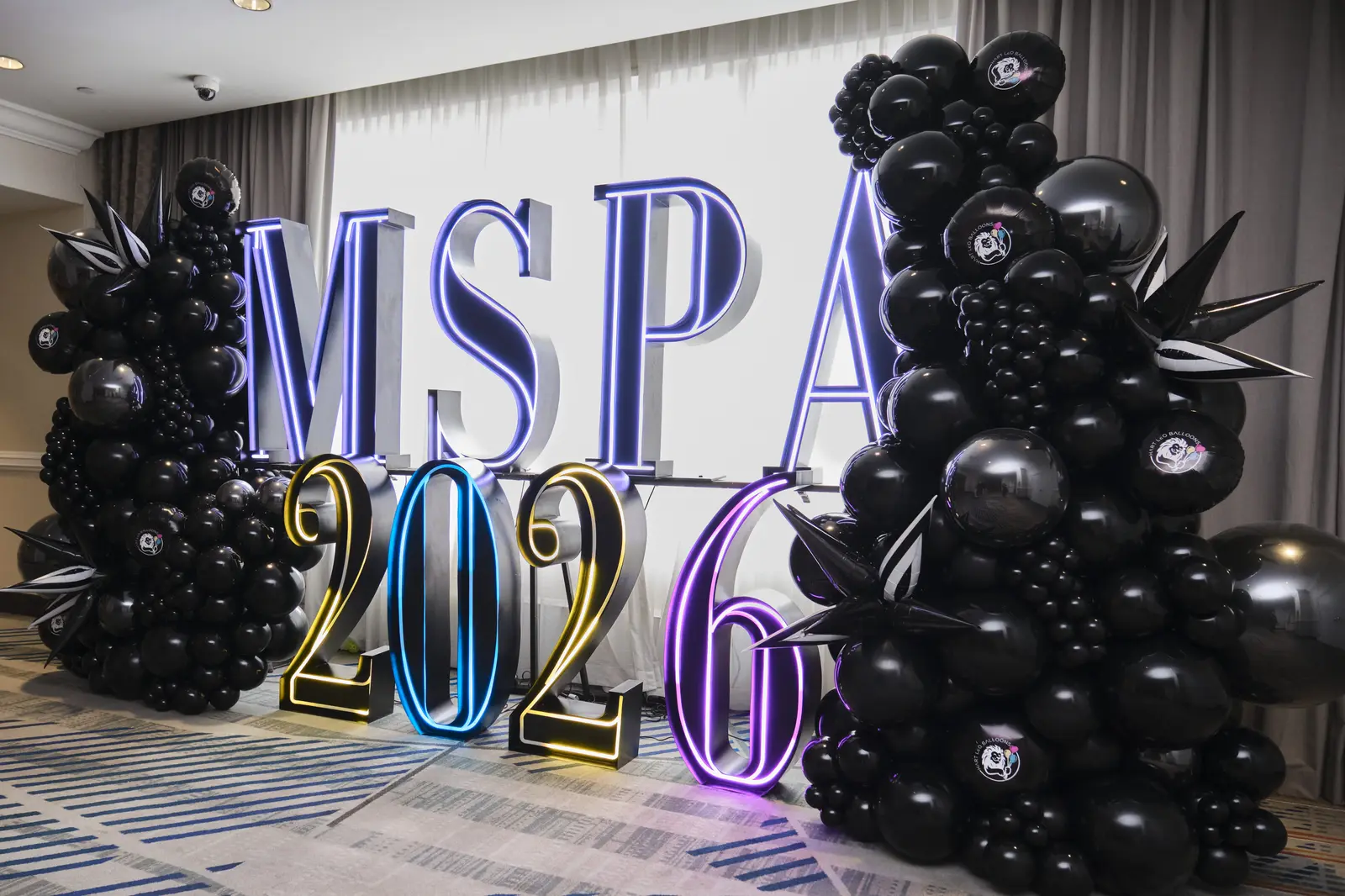 MSPA 2026 event display with black balloon decorations