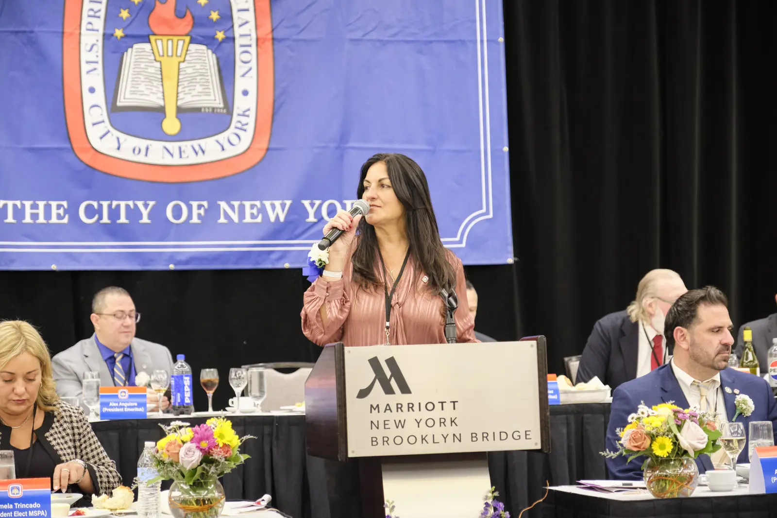 Woman speaking at podium during New York City event