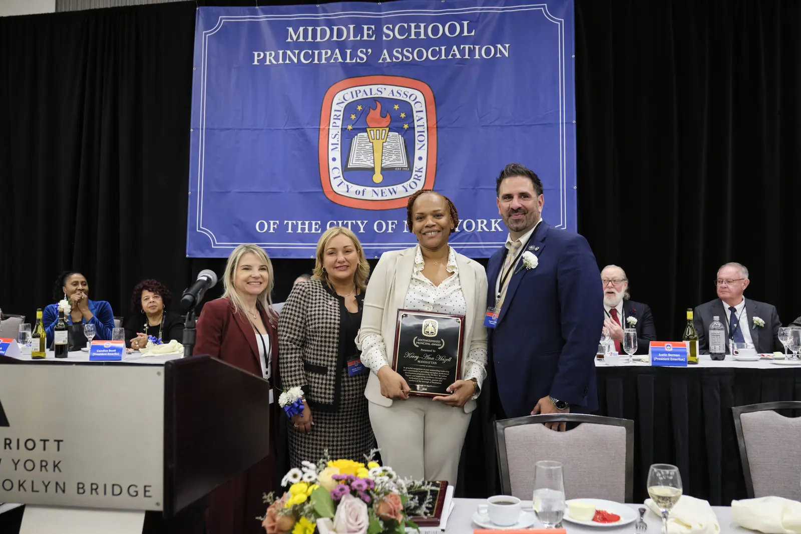 Principal receives award plaque at Middle School Principals' Association ceremony