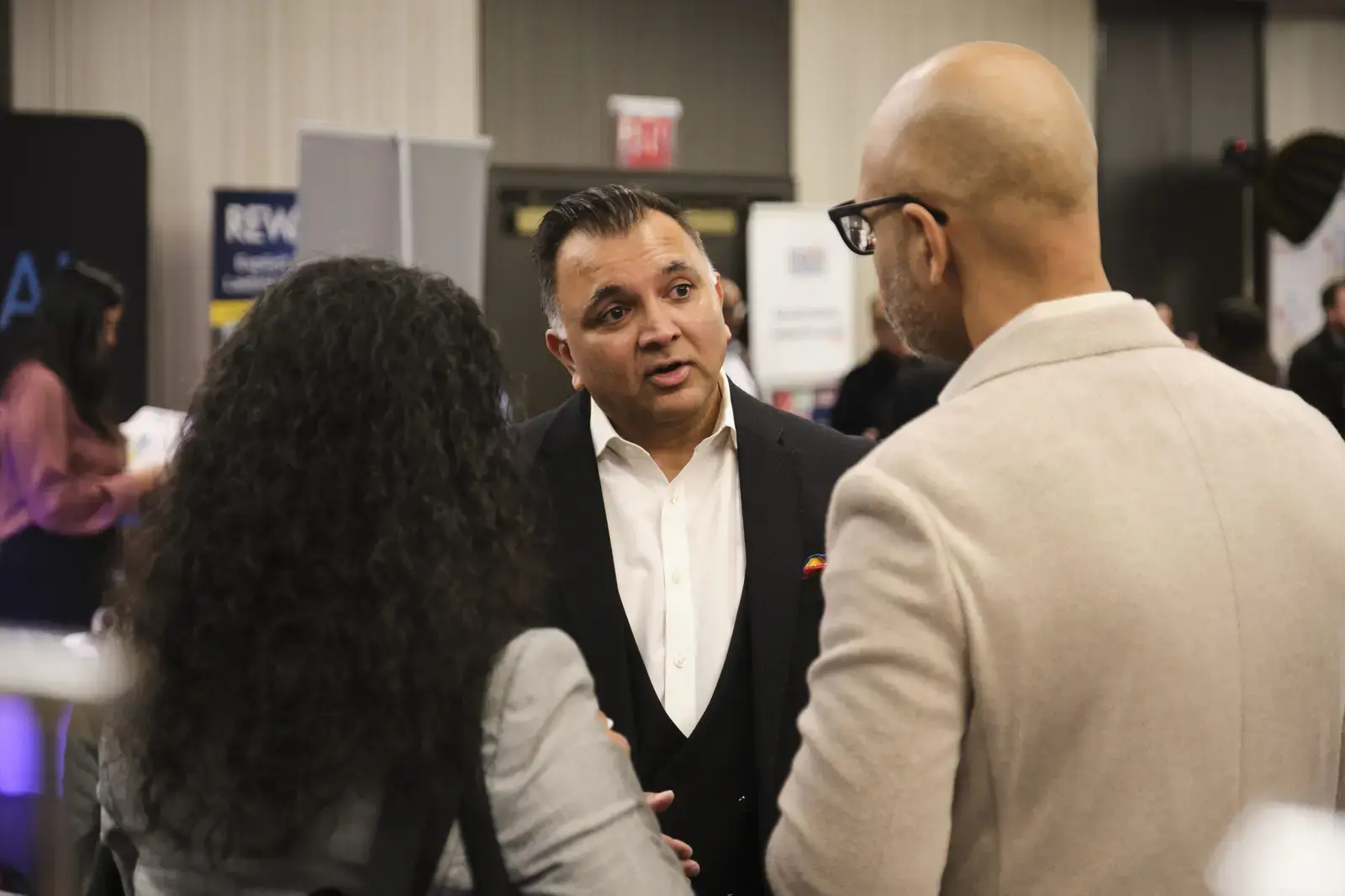 Professional networking conversation at school event