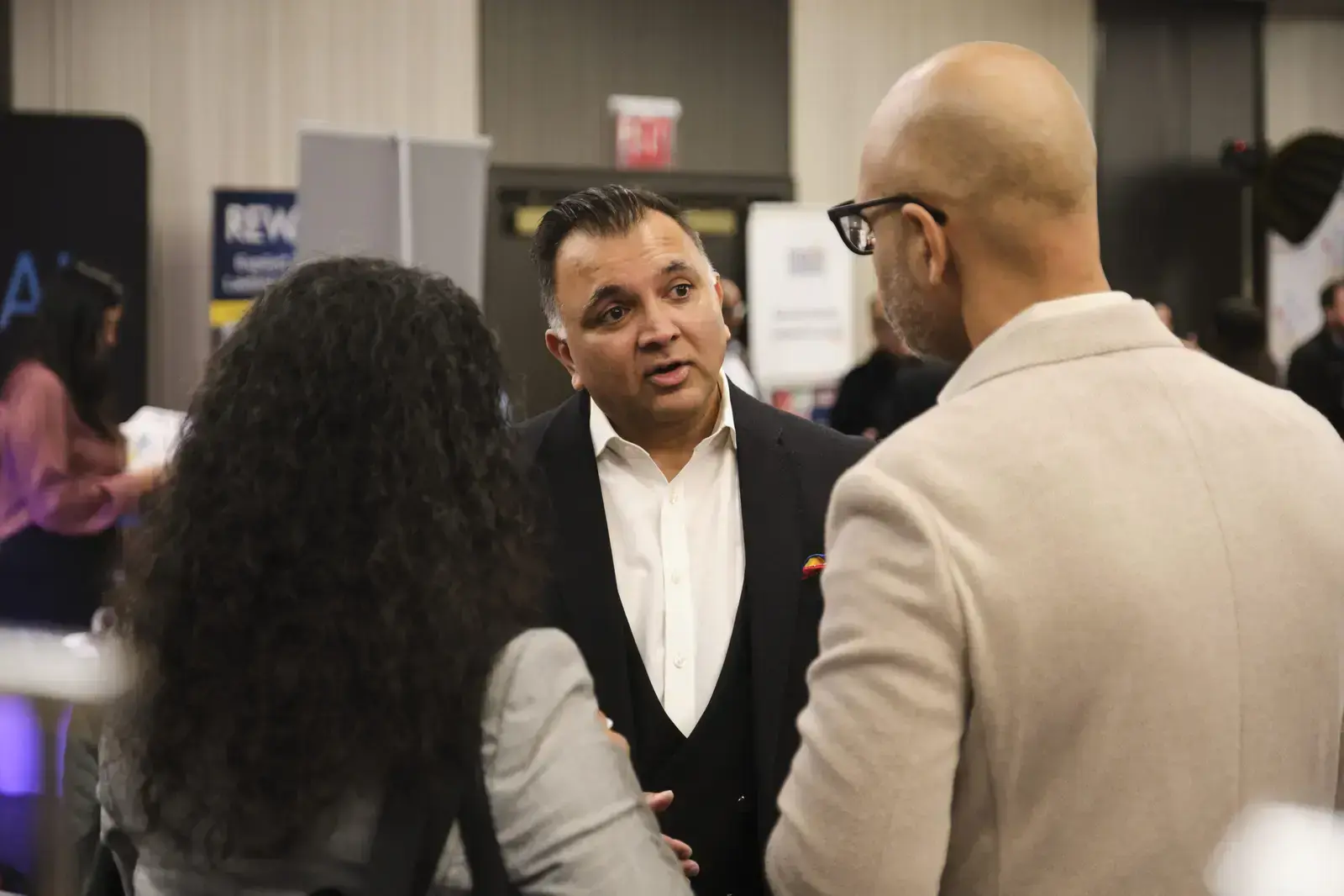 Professional networking conversation at school event