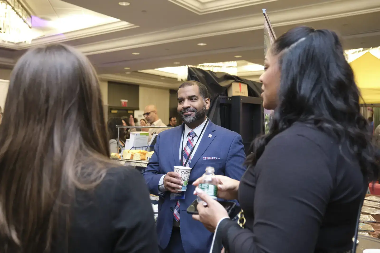 Professional networking at school event with refreshments