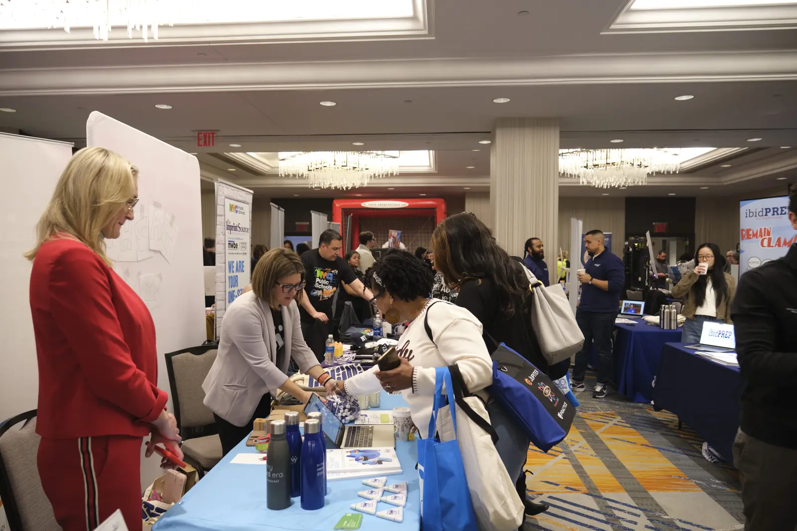 Attendees networking with exhibitors at school resource fair