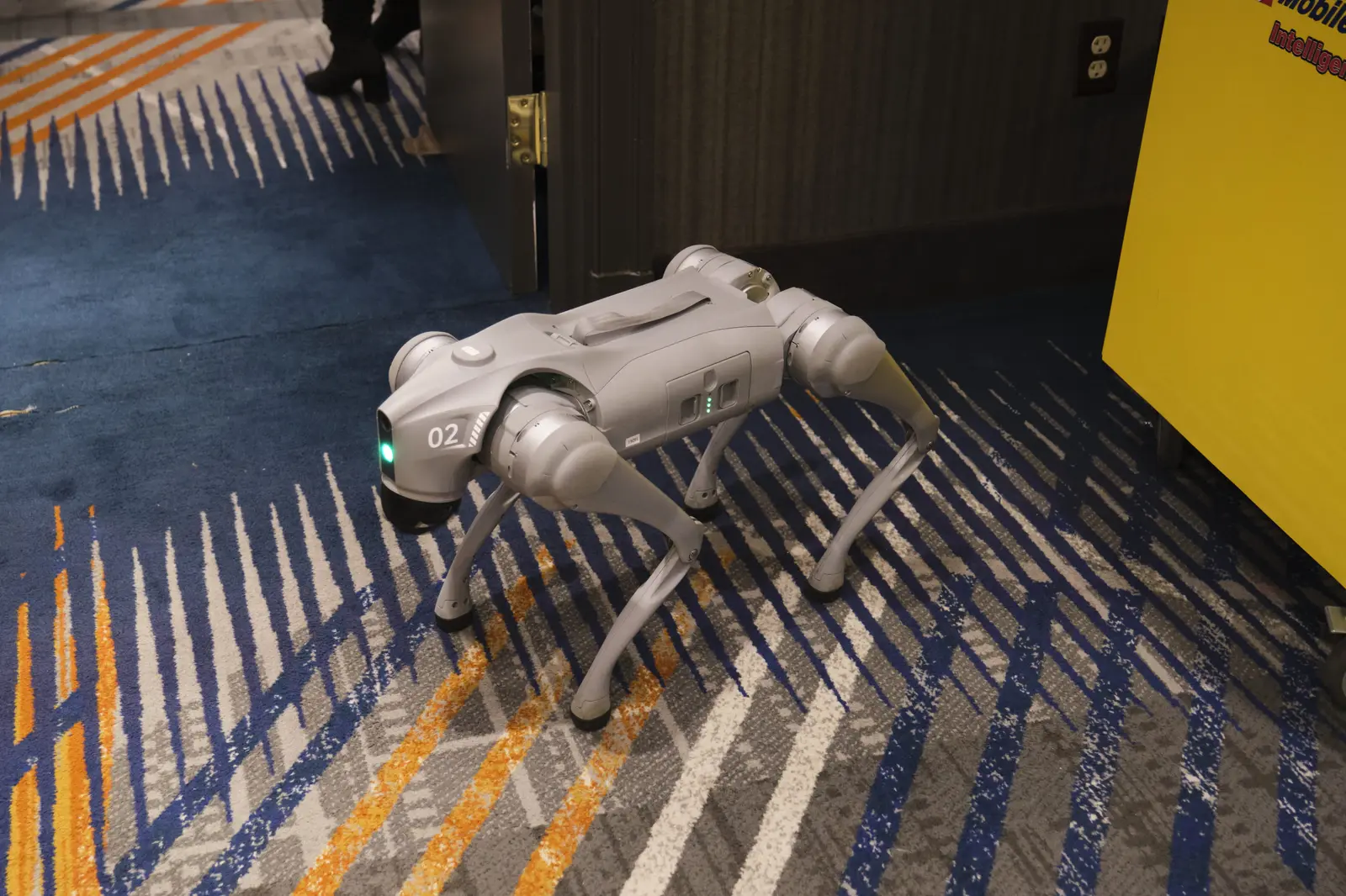 Four-legged robot dog standing on patterned carpet