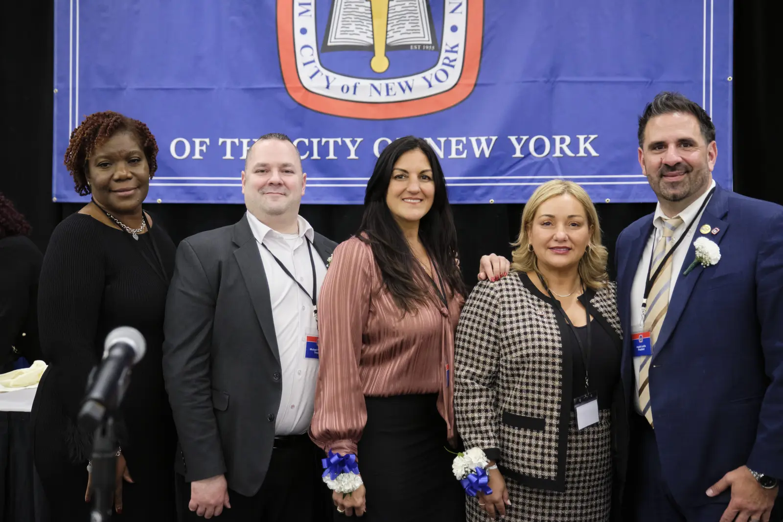 Five staff members pose together at City of New York event