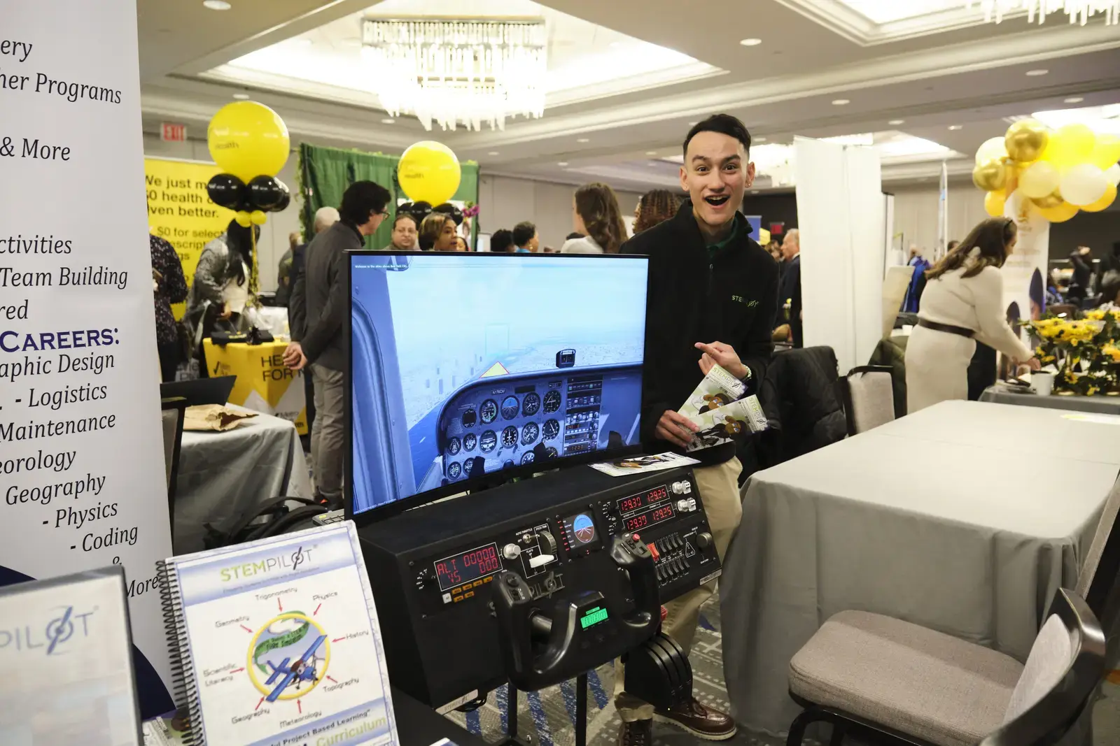 Student presents flight simulator at career fair booth