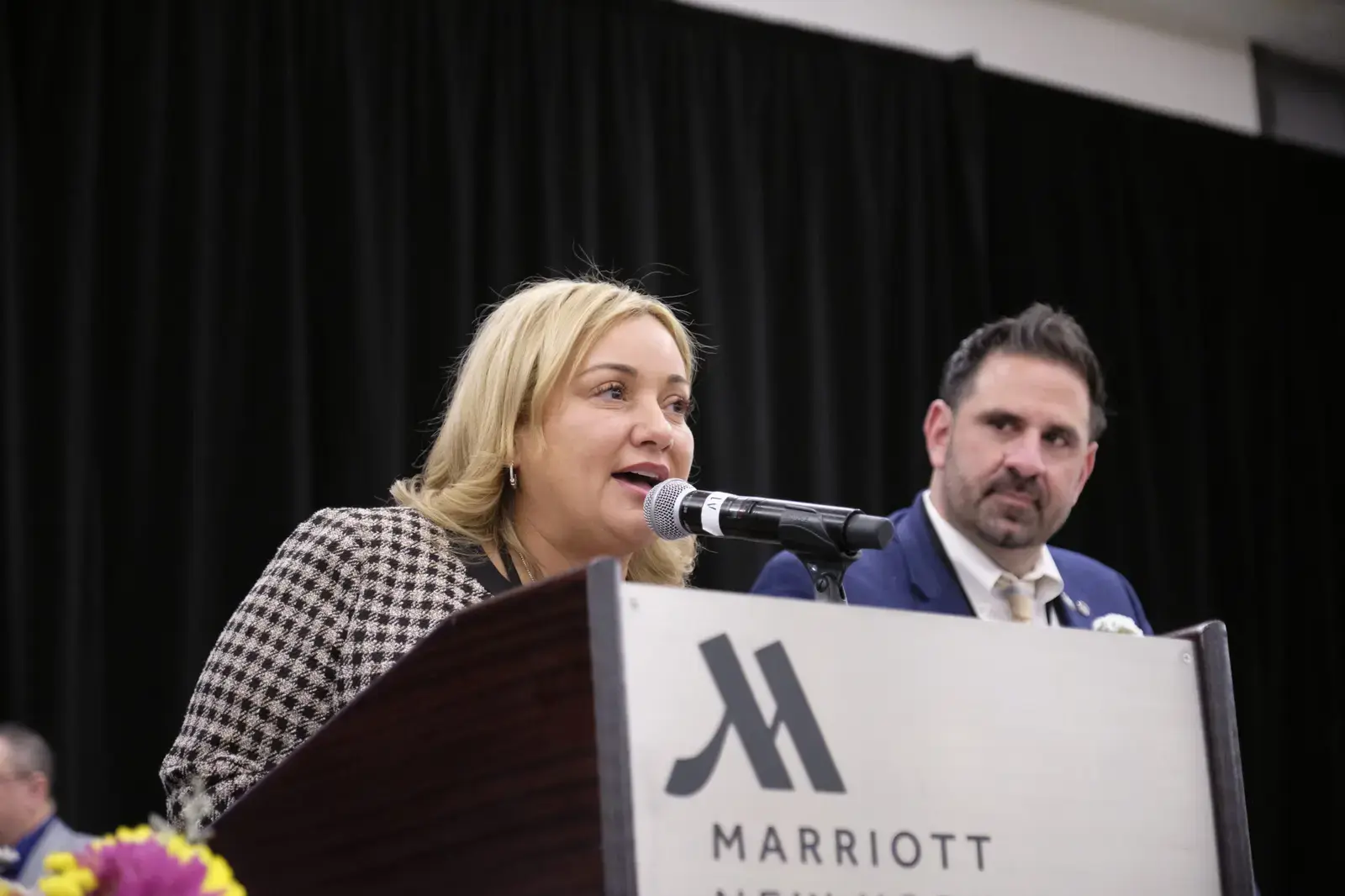 Woman speaking at podium during school event