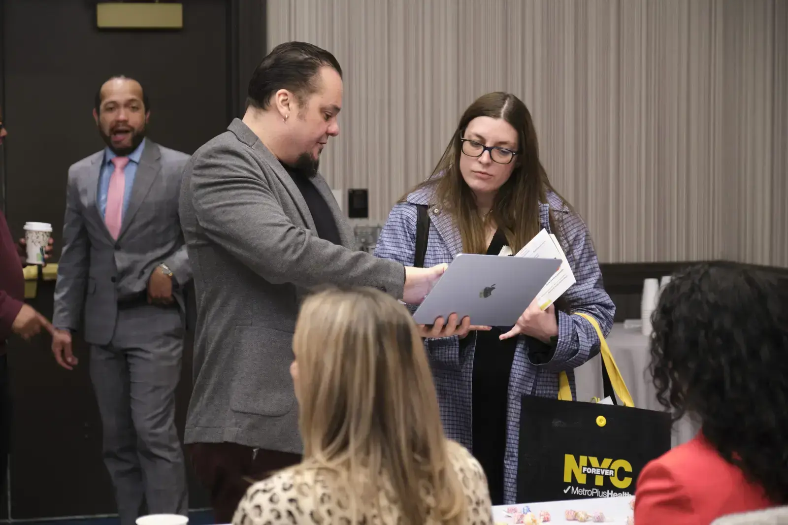 Two people reviewing documents at professional development event