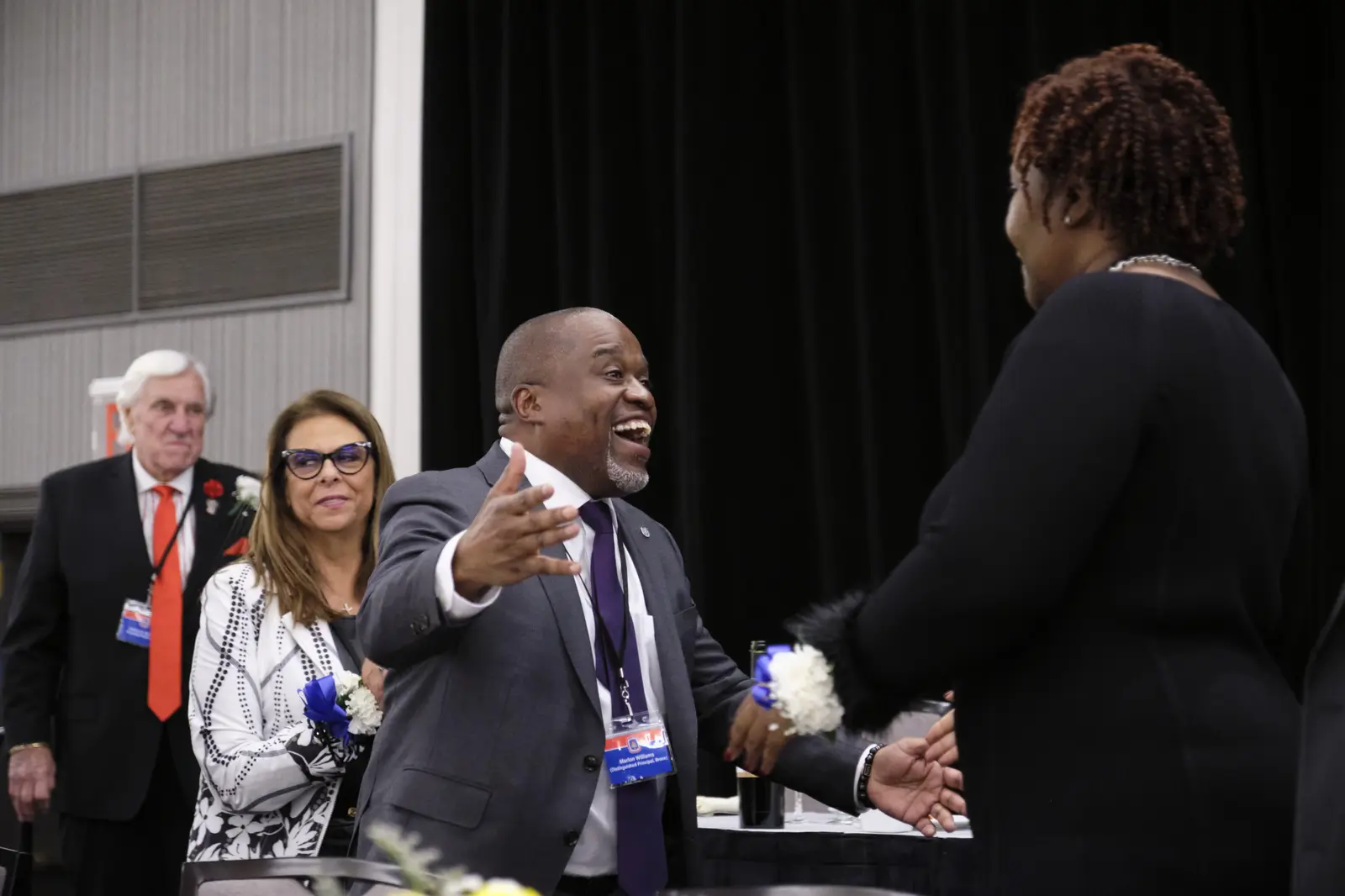 Graduate shakes hands with administrator at commencement ceremony