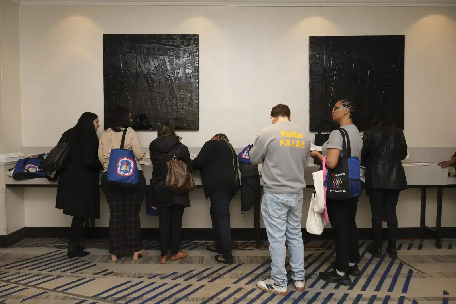 Students viewing artwork in museum gallery