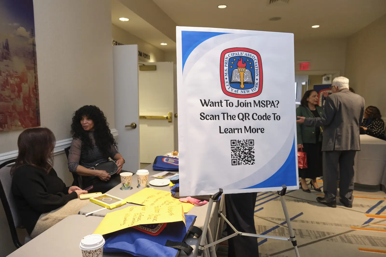 MSPA recruitment sign with QR code at school event table