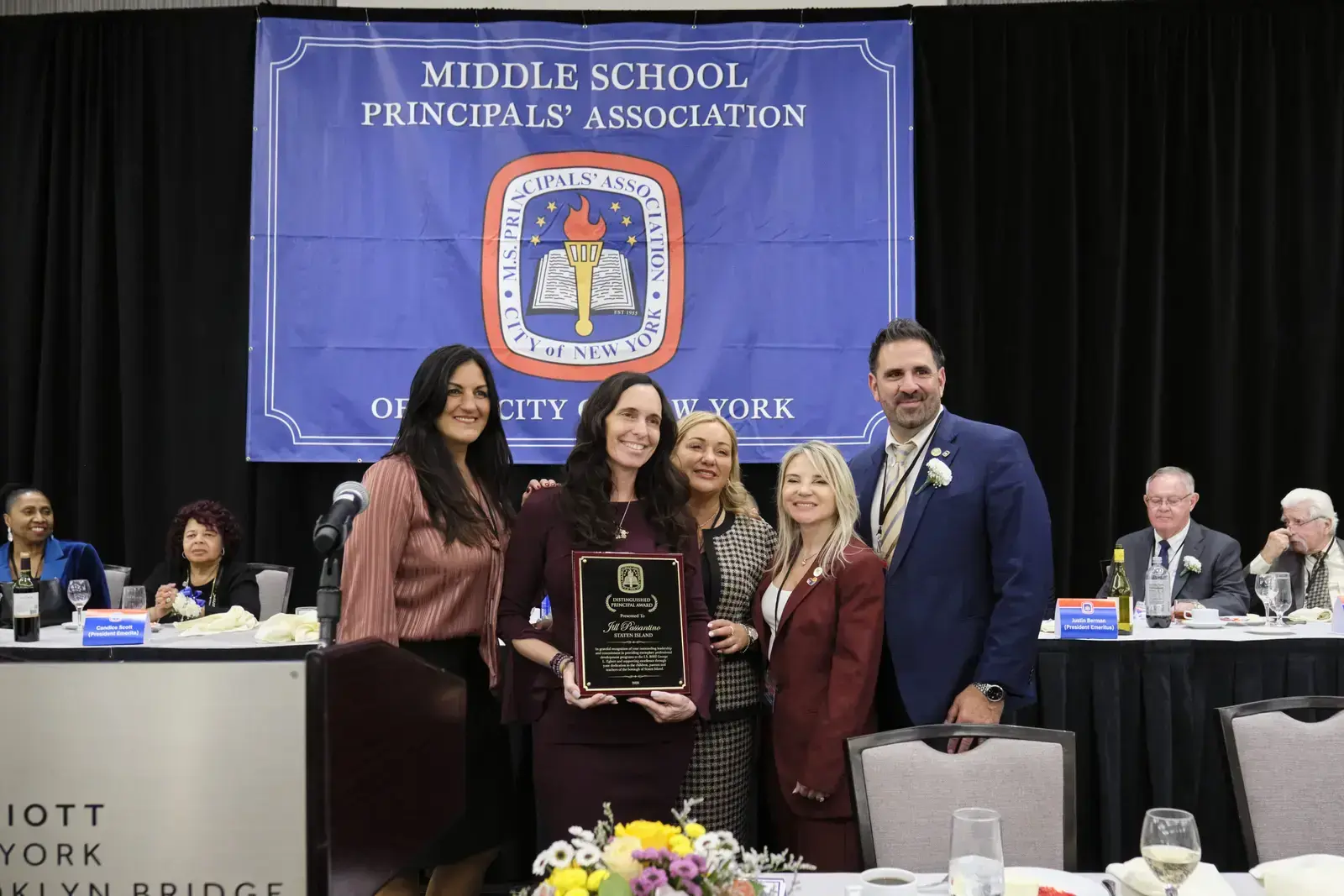 Five people pose with award plaque at Middle School Principals' Association event