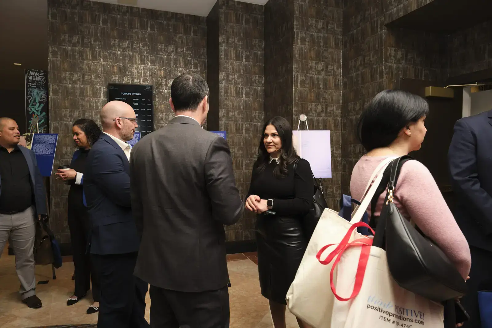 Professionals networking at formal event in modern venue