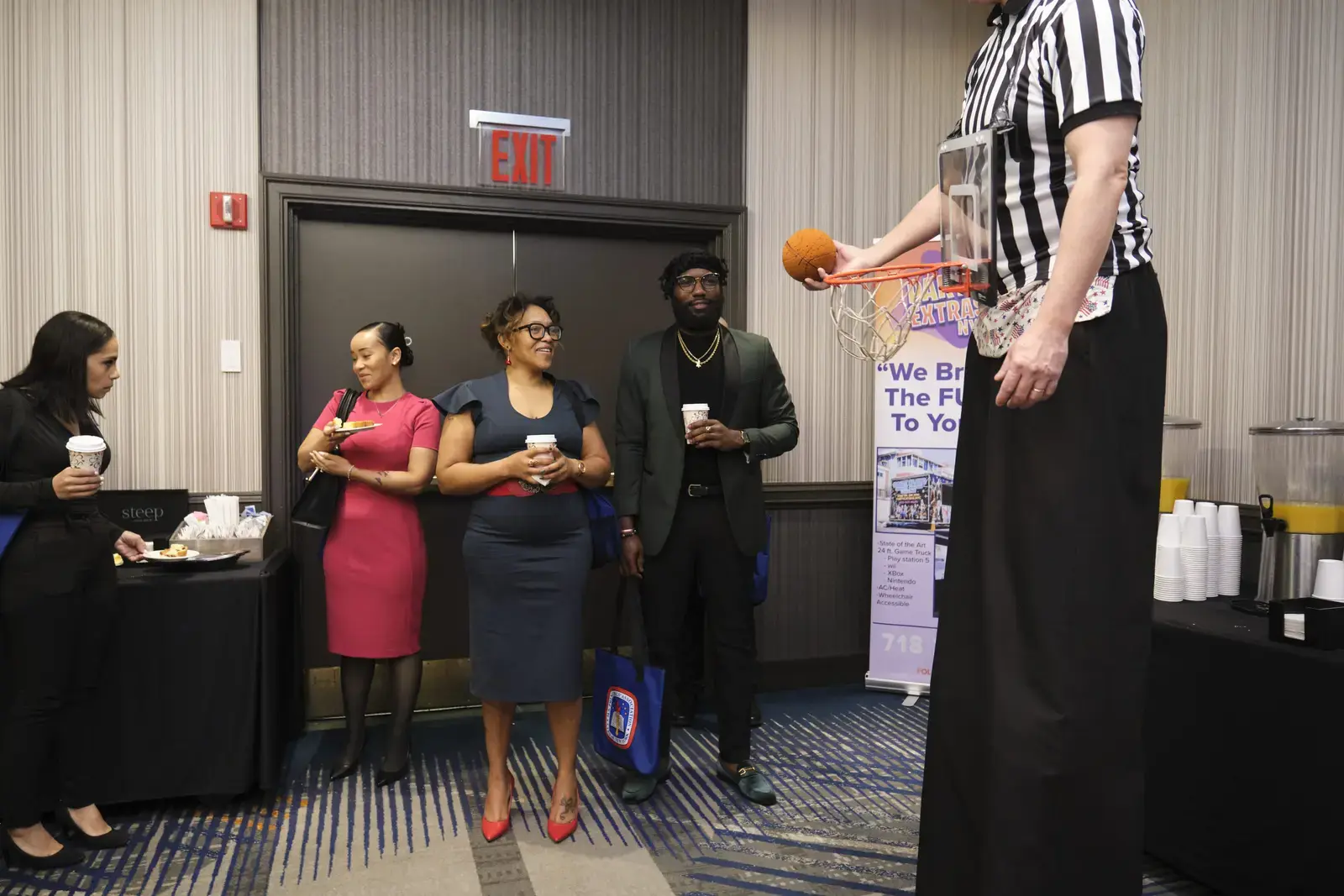 Referee demonstrating basketball shot at school community event