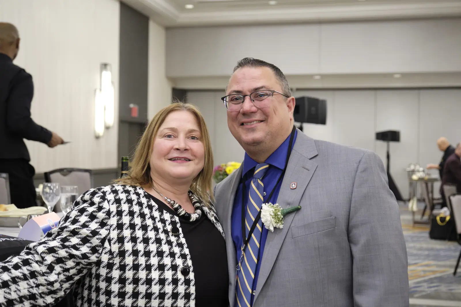 Two smiling people posing together at a formal event