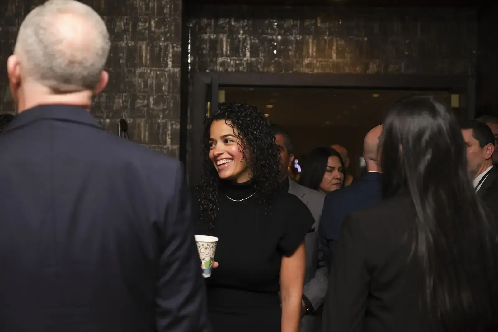 Attendees networking and conversing at school event