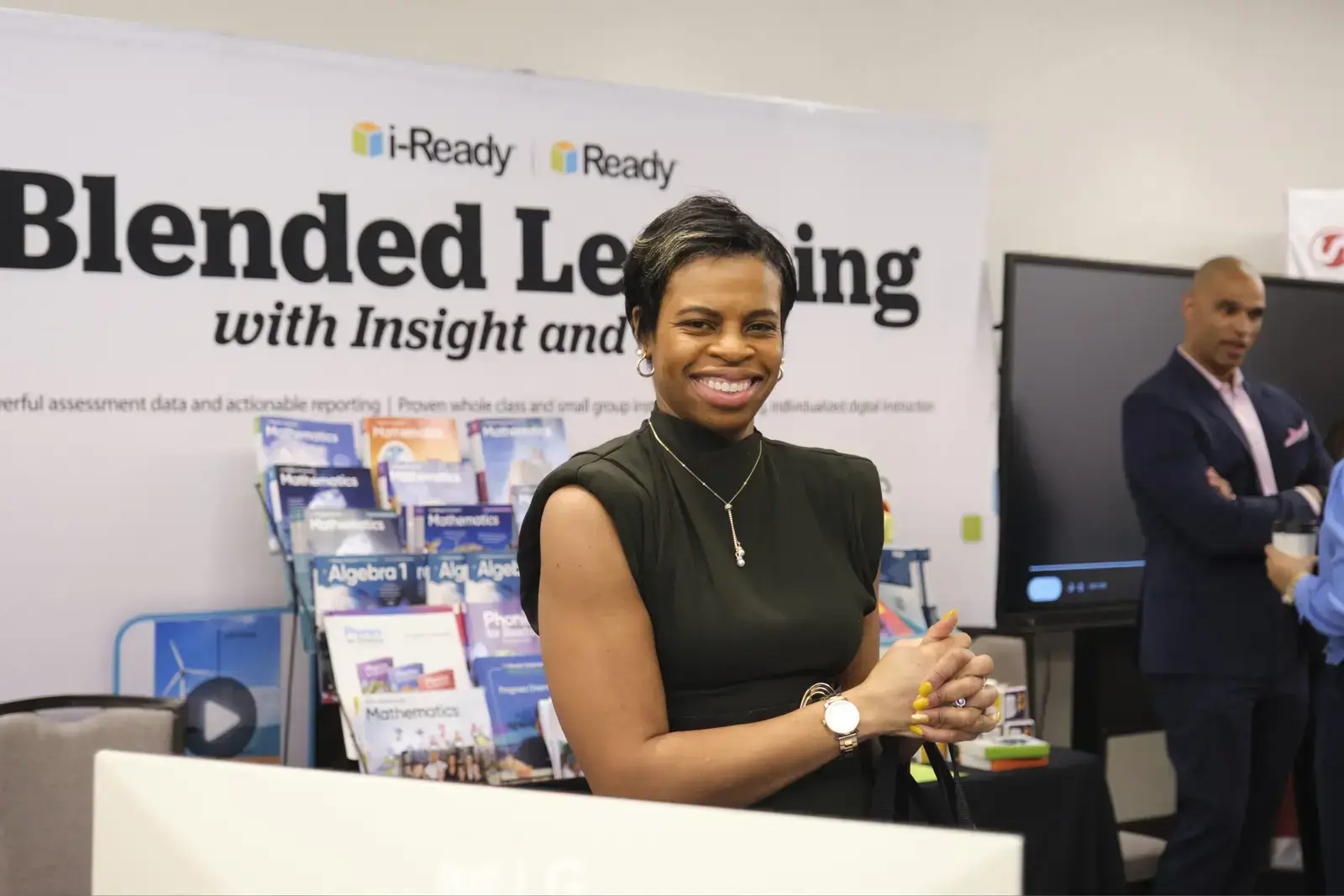 Representative at i-Ready blended learning booth at education conference