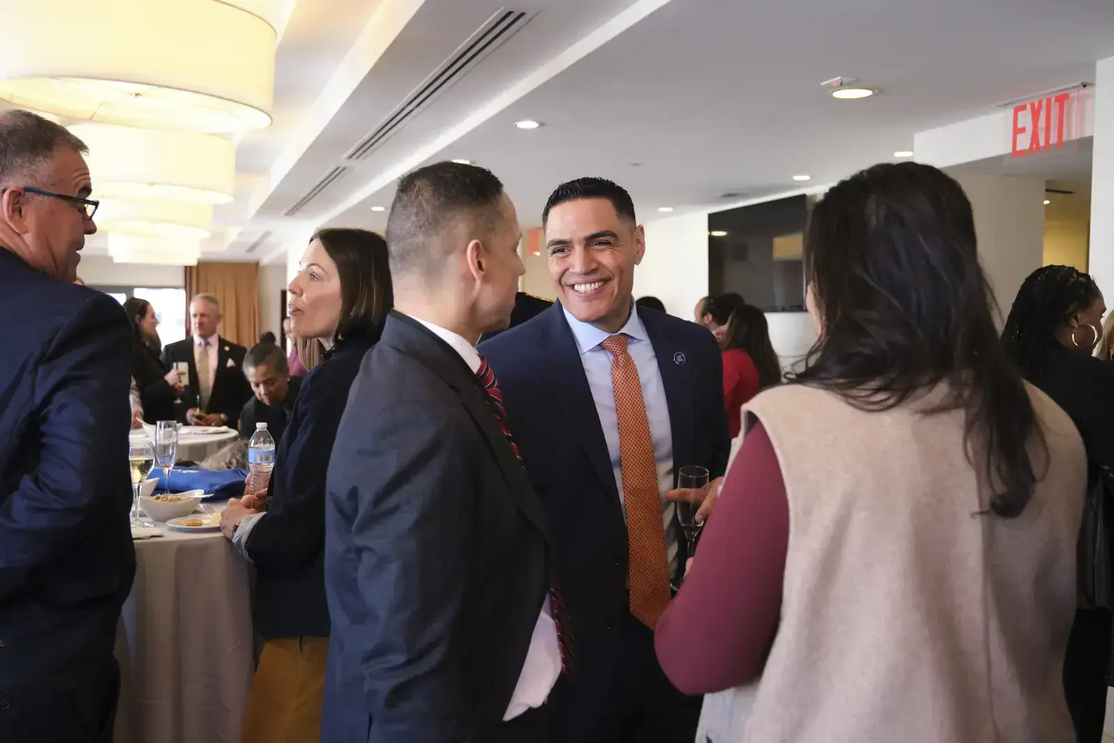 Professionals networking and conversing at school event reception