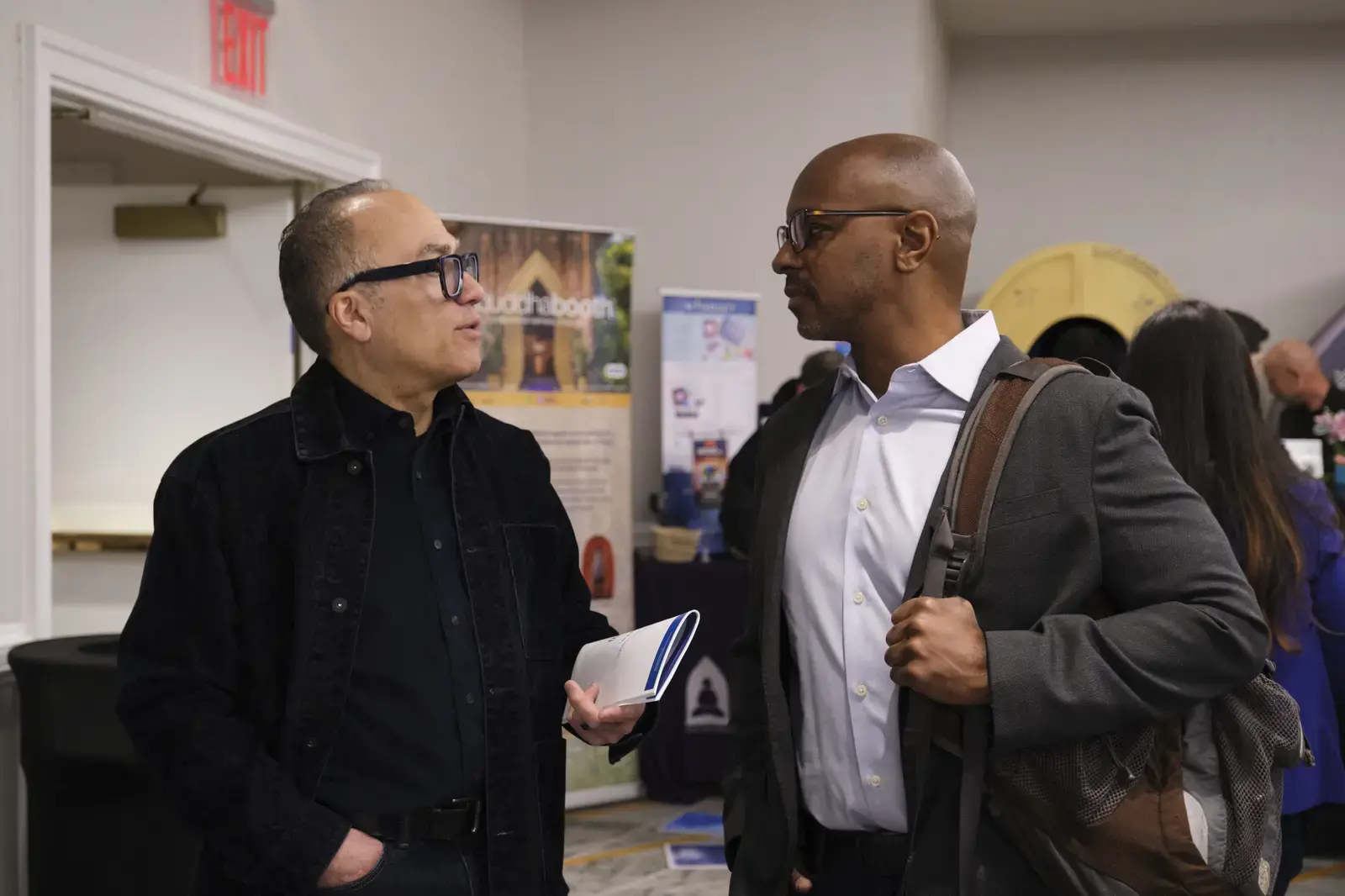 Two adults in conversation at a school event