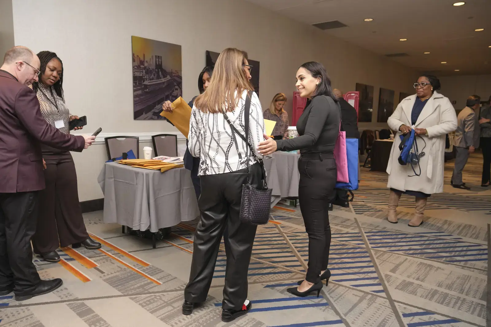 Attendees networking and conversing at professional event