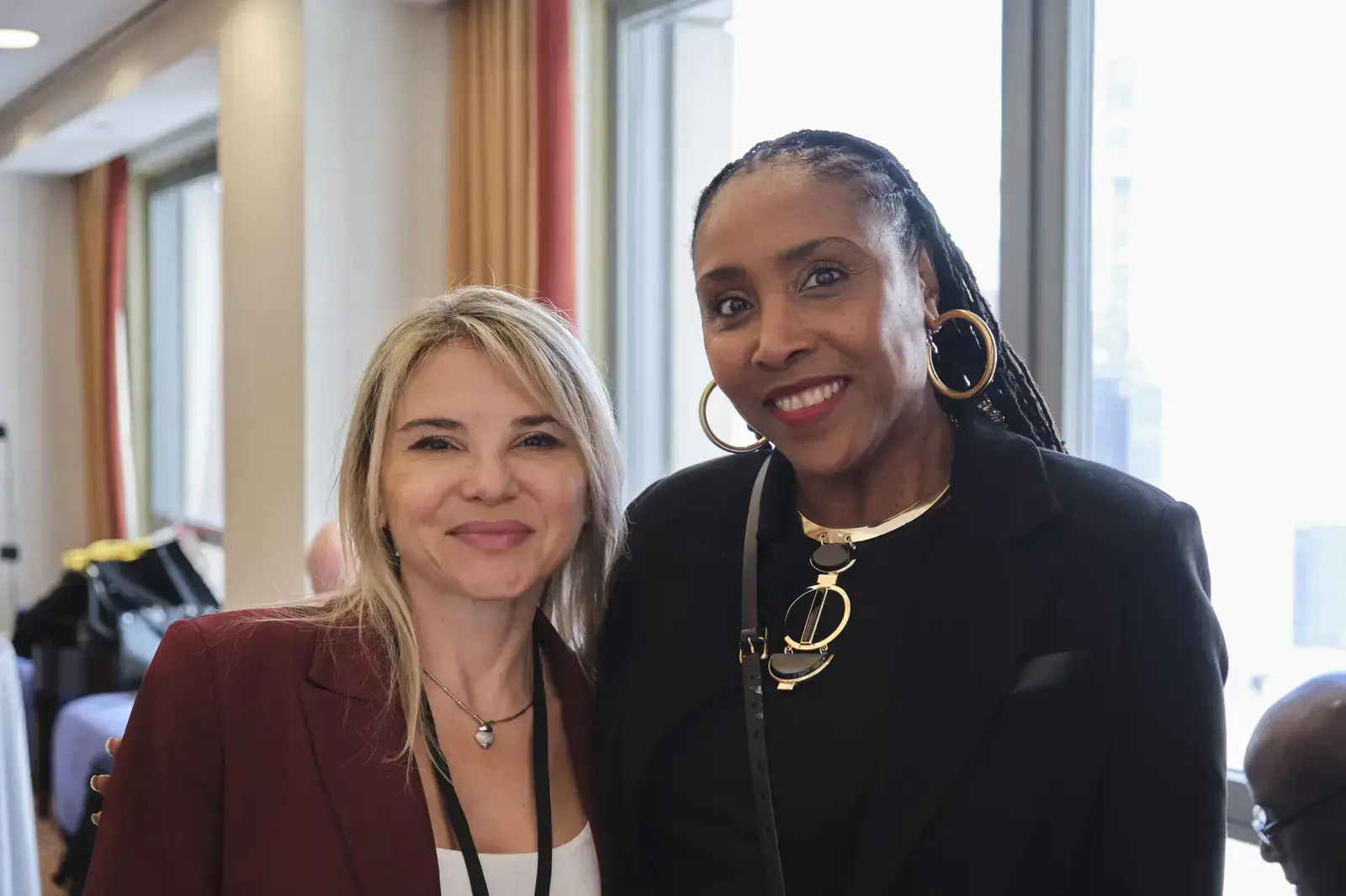 Two women smiling together at a school event