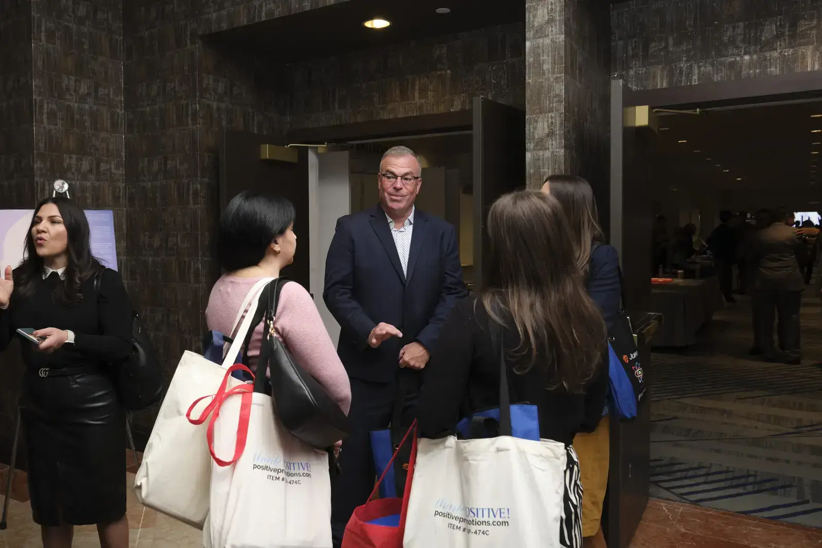 School administrator speaking with students in lobby area