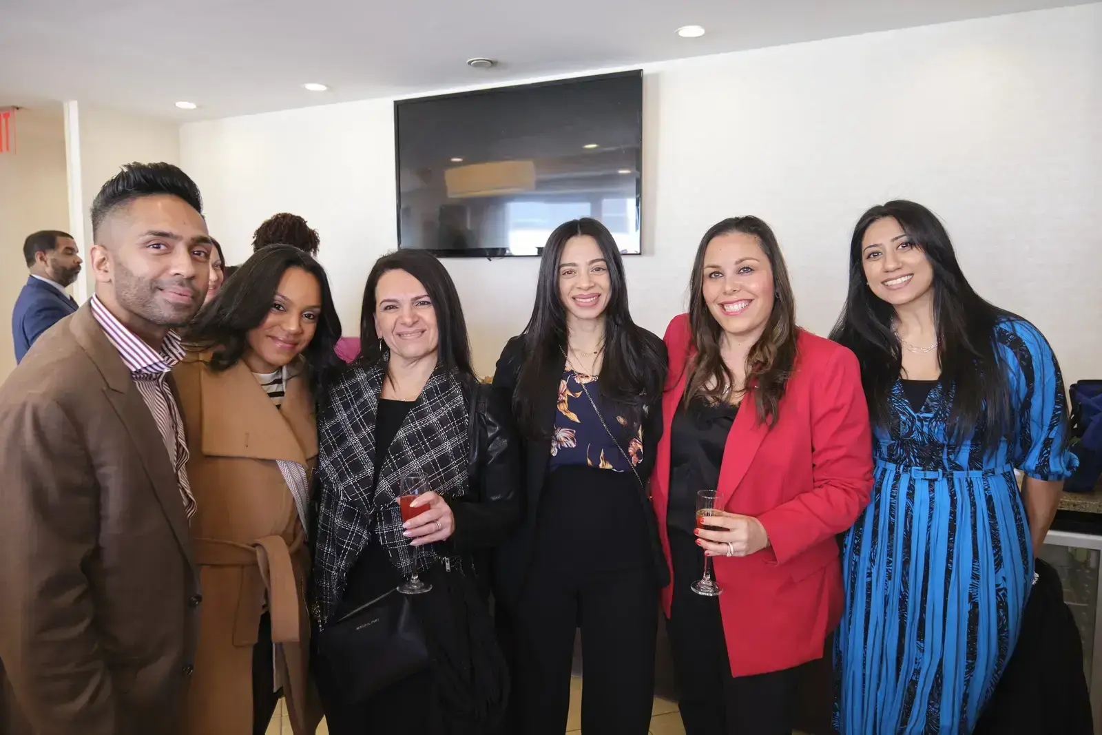 Group of six professionals posing together at school event