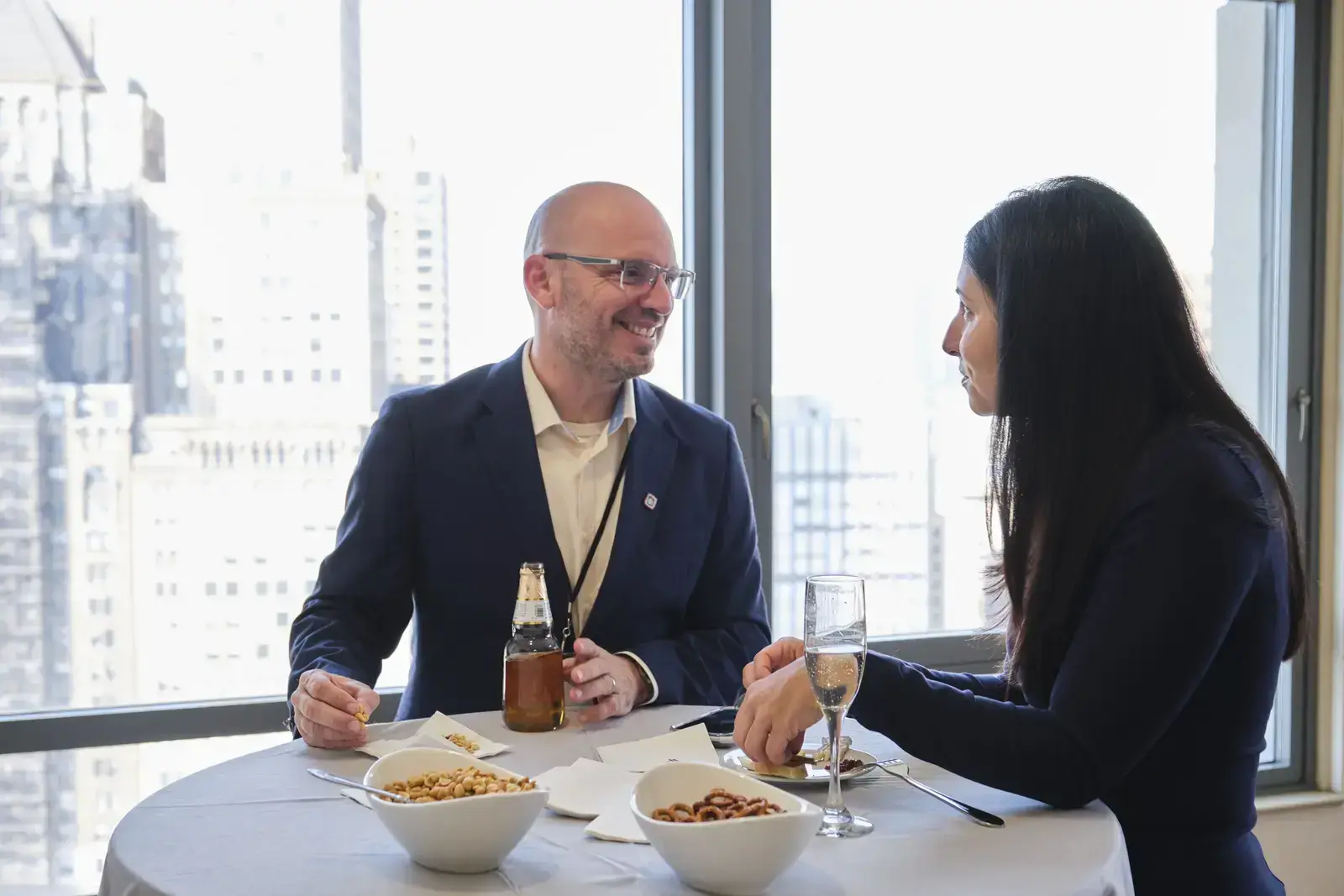 Two professionals having a business meeting over refreshments