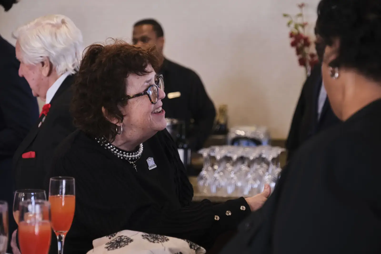 Guests mingling and conversing at formal school event