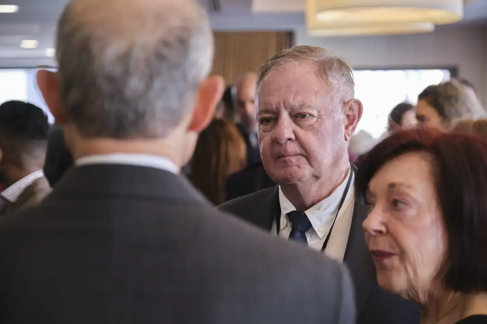 Attendees networking and conversing at school event