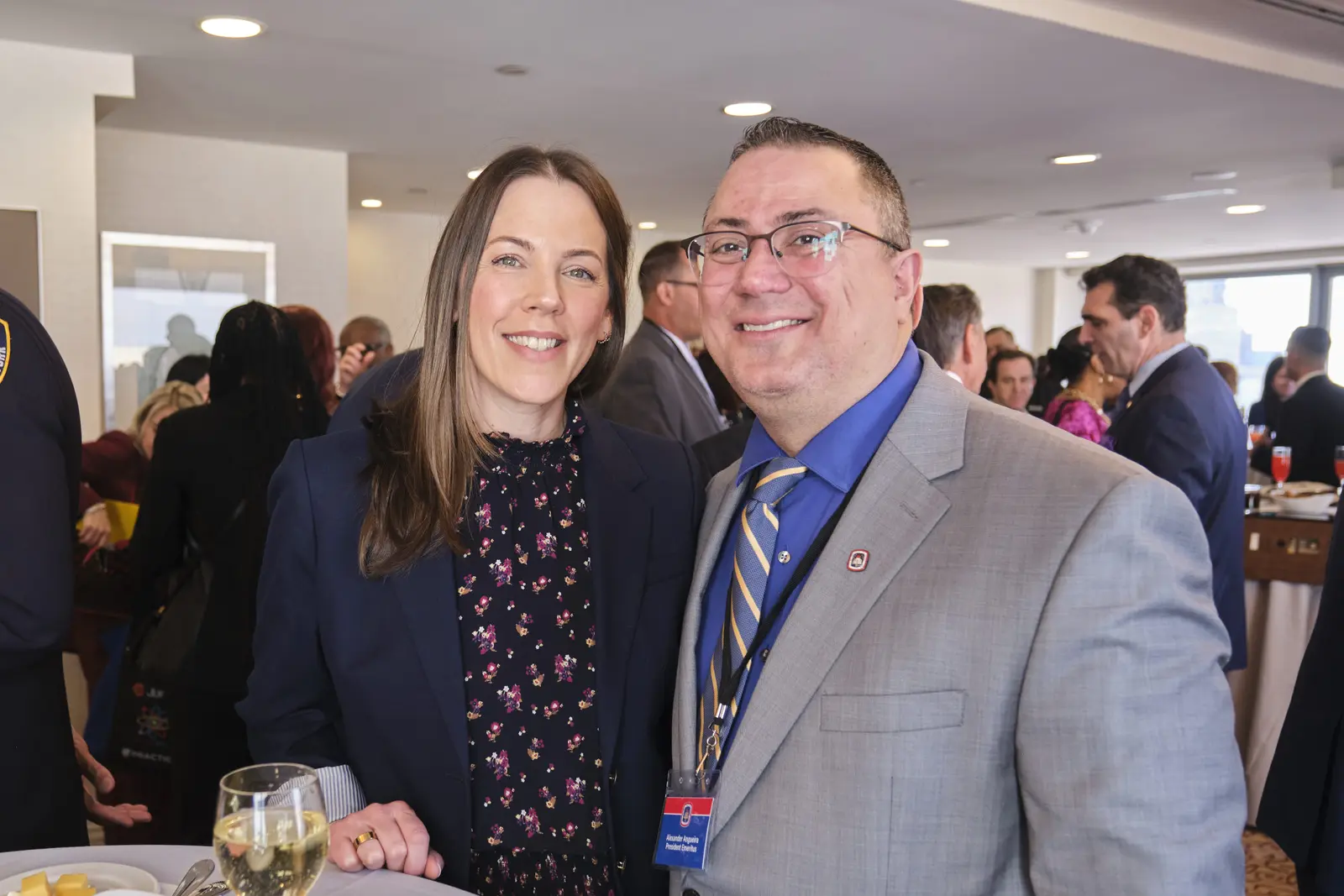Two educators smiling together at school networking event
