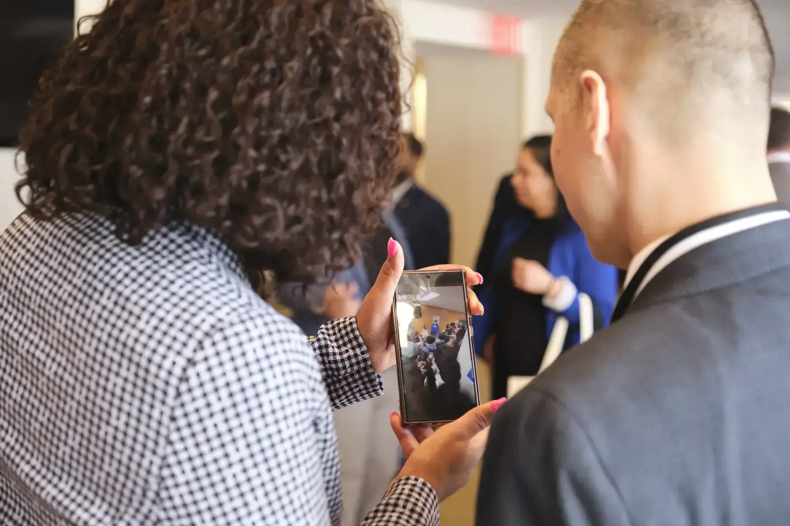 Students viewing photo on smartphone together