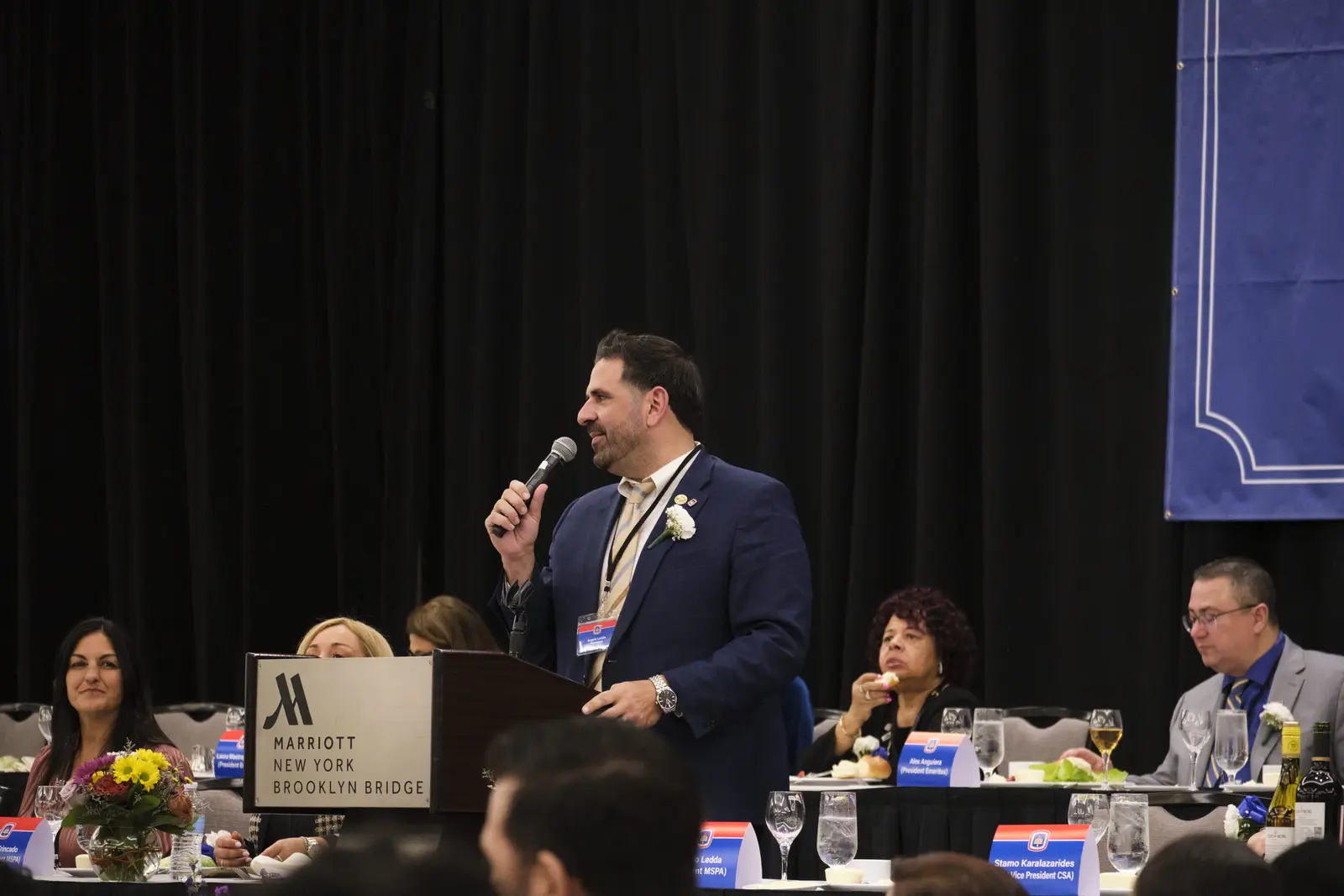 Speaker addressing attendees at formal event or banquet