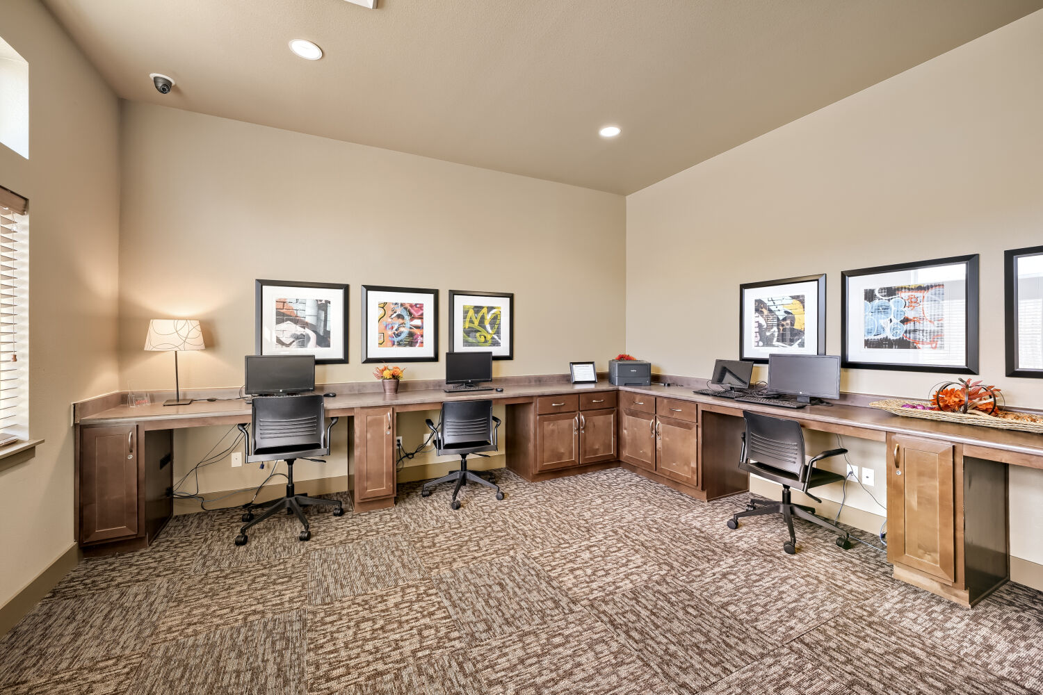 Business center at Copper Hill Apartments with computer workstations and workspace for residents in Spokane, Washington