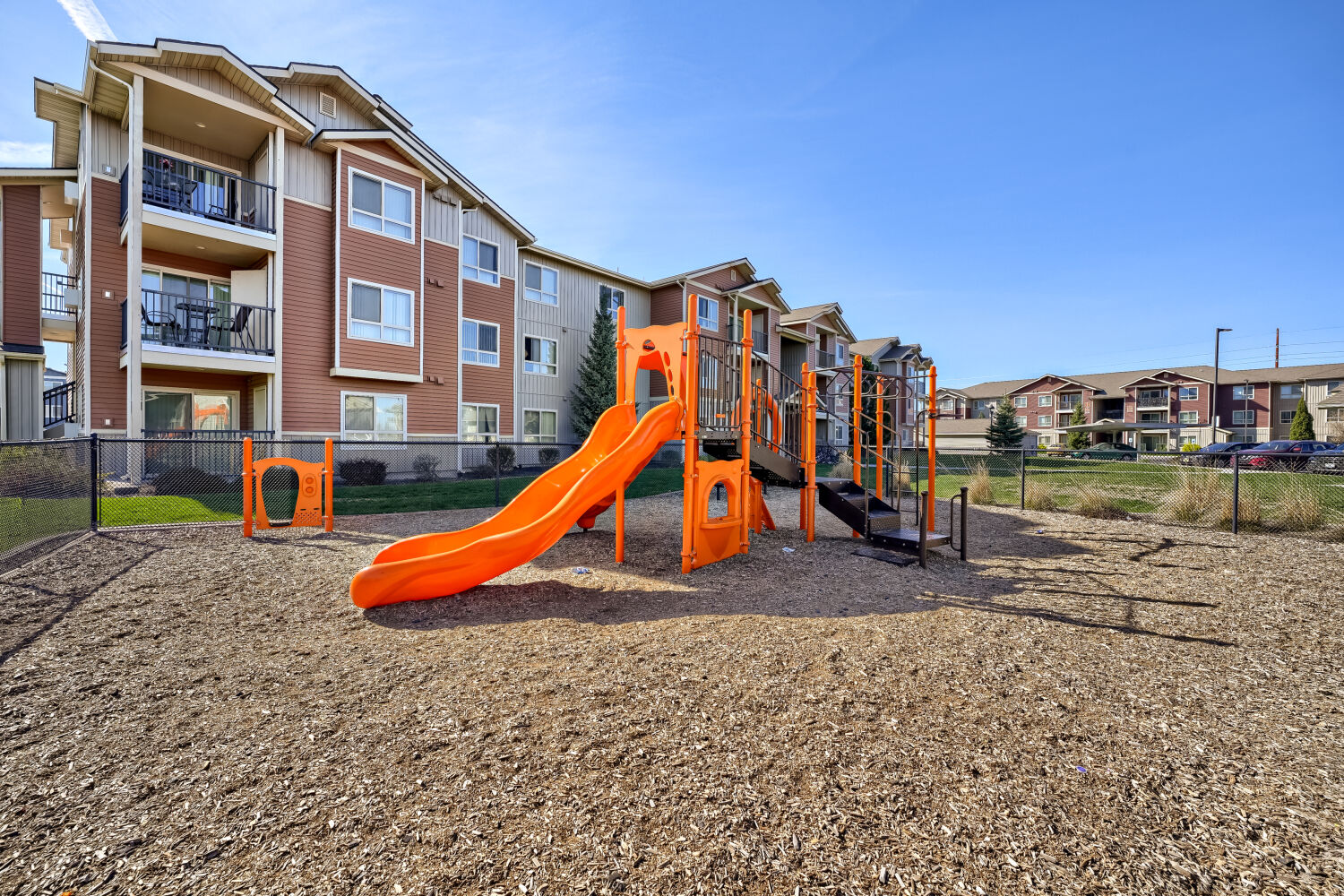 Community playground at Copper Hill Apartments with modern play equipment and spacious outdoor recreation area in Spokane, Washington