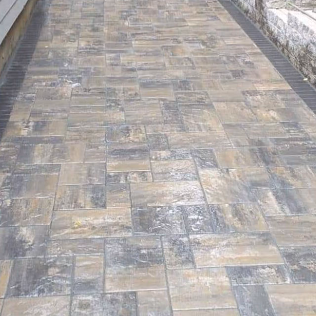 Custom backyard paver patio by Roi Property Services designed for proper drainage and lasting outdoor performance in Metro Detroit